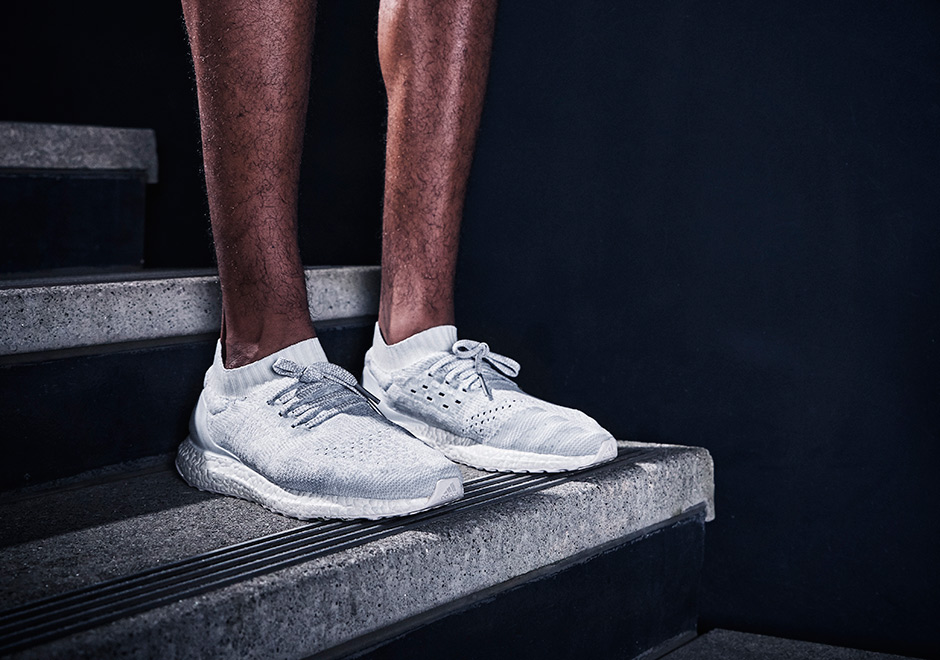 ultra boost uncaged white reflective on feet